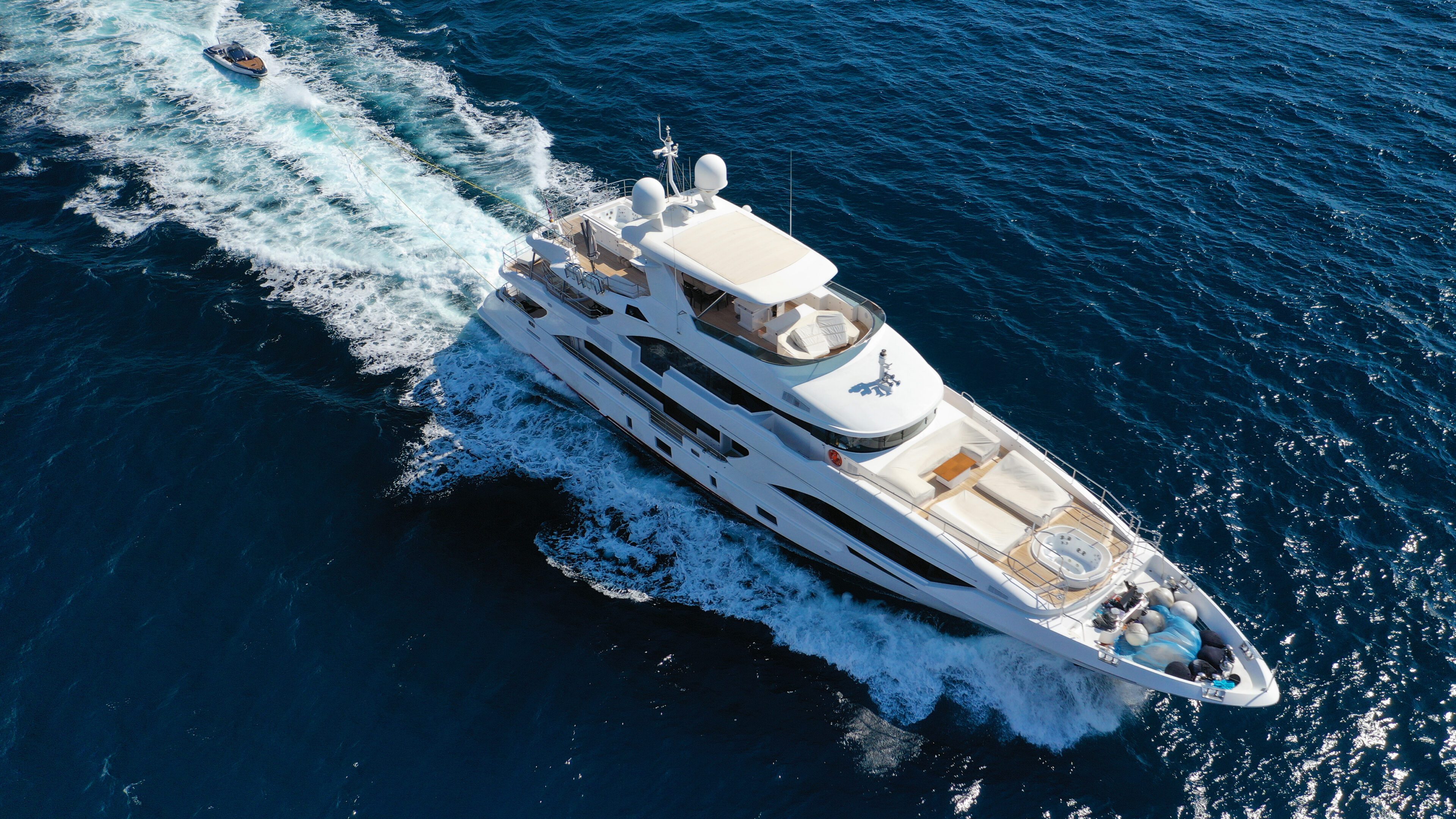 Luxury yacht cruising on deep blue ocean waters.