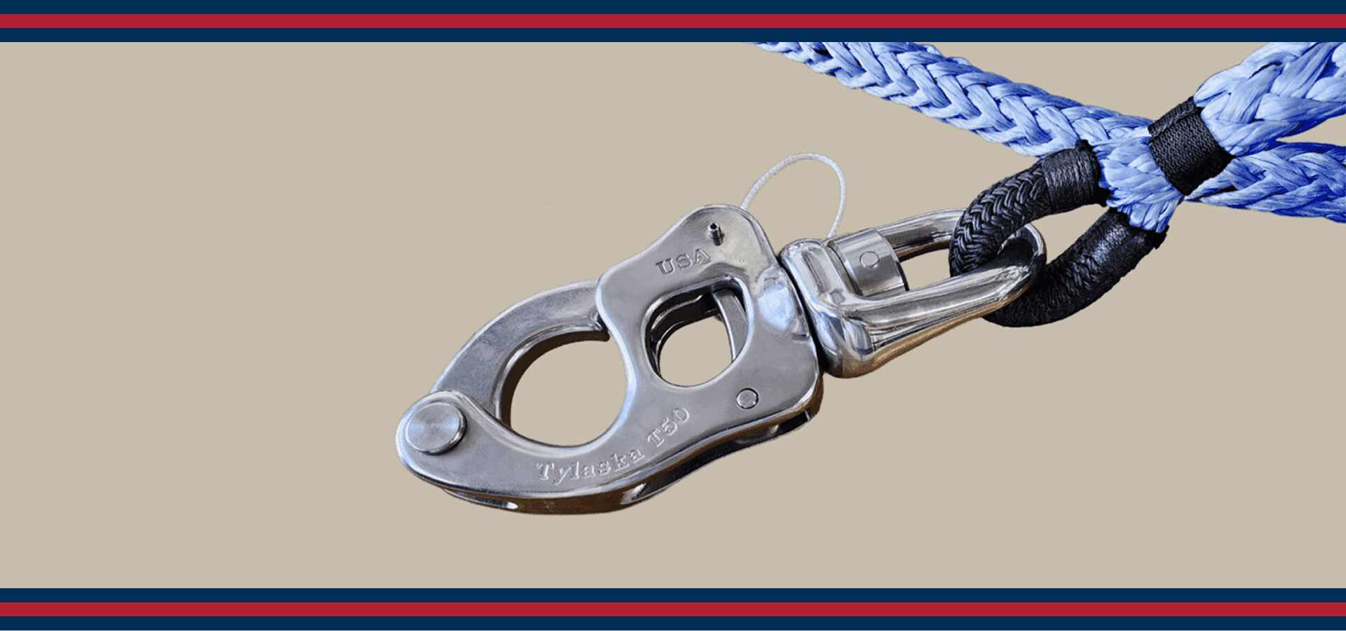 Close-up of a metal carabiner attached to a blue and white braided rope.